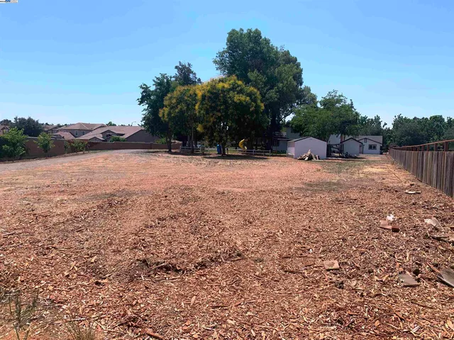 a view of a house with a yard patio and fire pit
