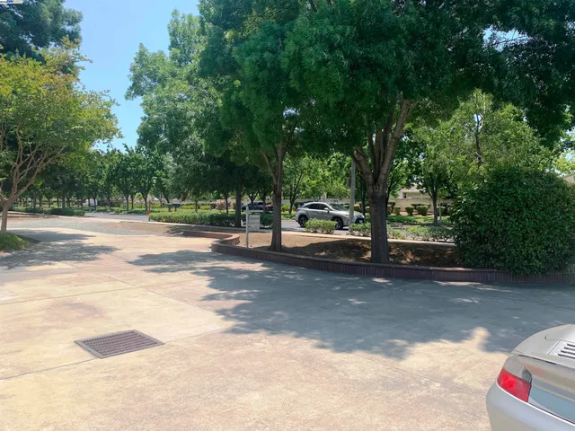 a kitchen with stainless steel appliances granite countertop a refrigerator a stove top oven a sink and dishwasher