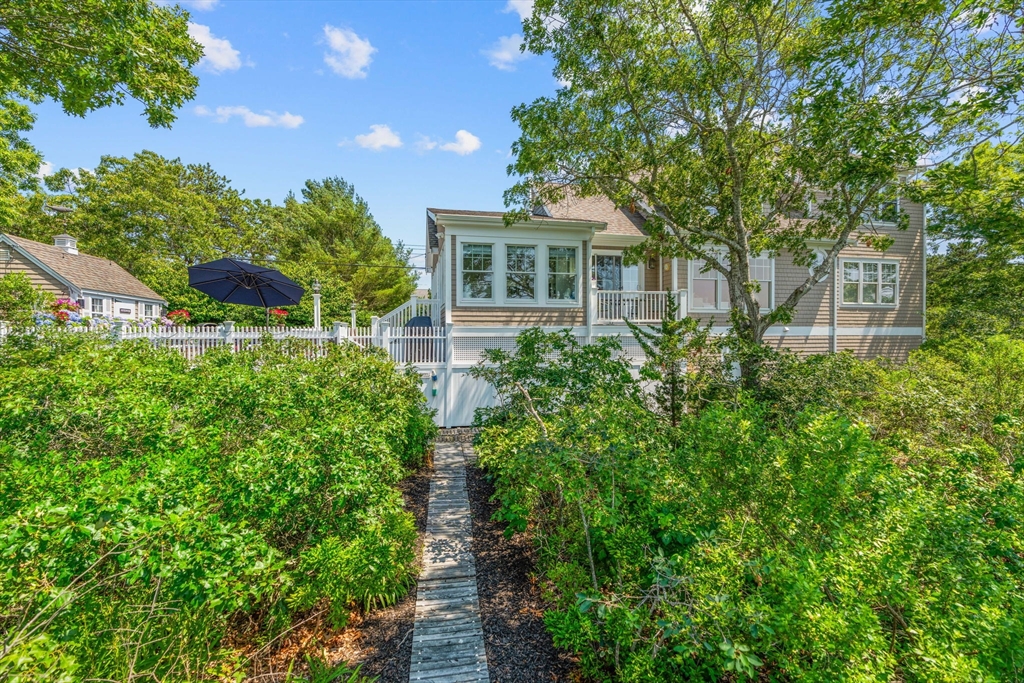 265 Monomoscoy Road Mashpee, MA 02649 - Photo 16 of 39 a front view of a house with a yard