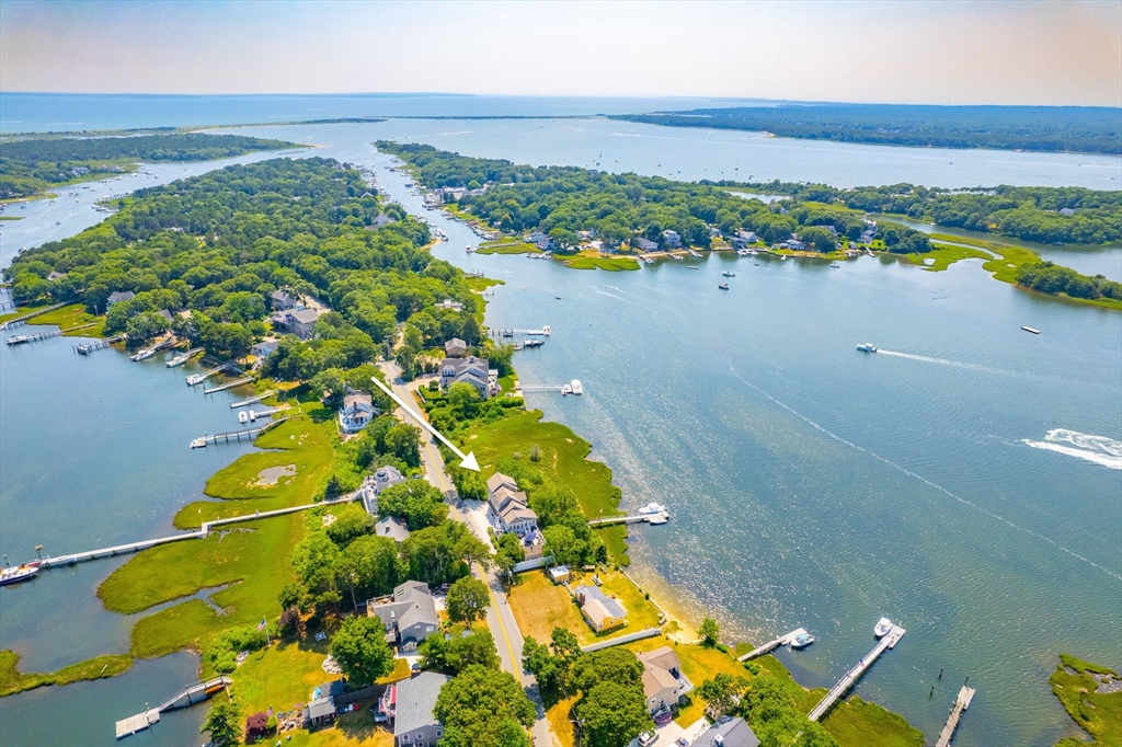265 Monomoscoy Road Mashpee, MA 02649 - Photo 5 of 39 a view of a lake with a mountain in the background