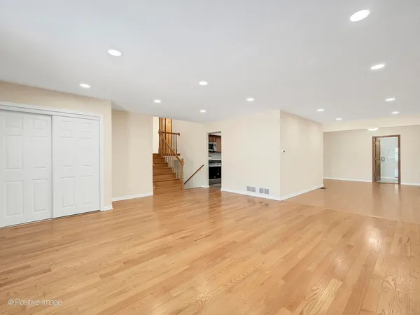 a view of an empty room with wooden floor