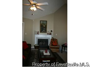 5018 Summer Ridge Road Fayetteville, NC 28303 - Photo 5 of 10 a living room with furniture and a fireplace