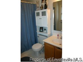 5018 Summer Ridge Road Fayetteville, NC 28303 - Photo 7 of 10 a bathroom with a toilet a sink and mirror