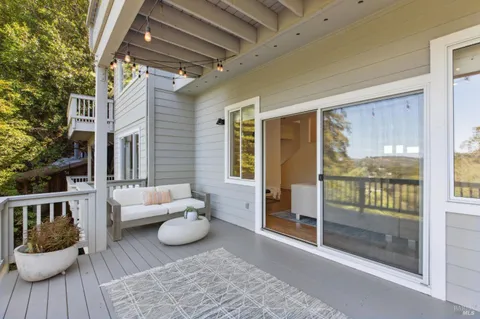 a kitchen with stainless steel appliances kitchen island granite countertop a dining table chairs and white cabinets