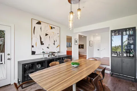 a kitchen with white cabinets and a large window
