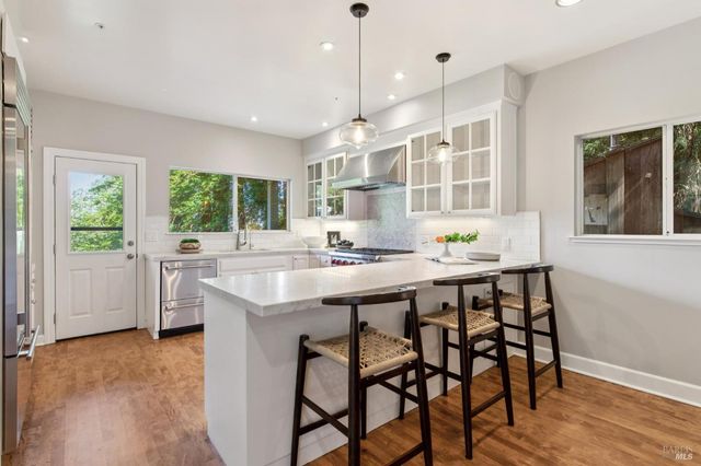 a living room with furniture and kitchen view