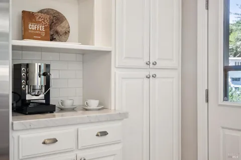 a view of a hallway with wooden floor and closet