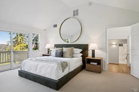 a bedroom with a bed and a lamp on table