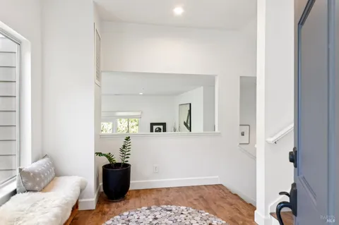 a living room with fireplace furniture and a large window