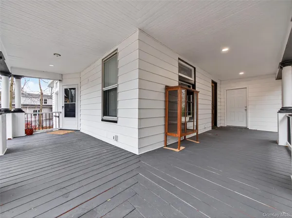 a view of a livingroom with wooden floor and an empty space