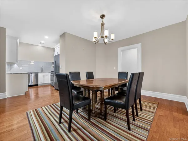 a view of a dining room with furniture wooden floor and chandelier