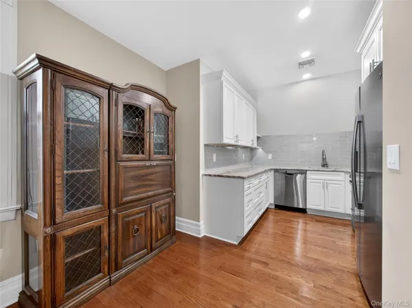 a kitchen with a refrigerator sink and cabinets