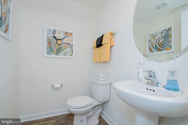 a bathroom with a sink and mirror with toilet