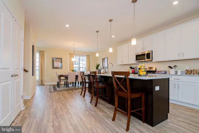 a large kitchen with lots of counter space and breakfast area
