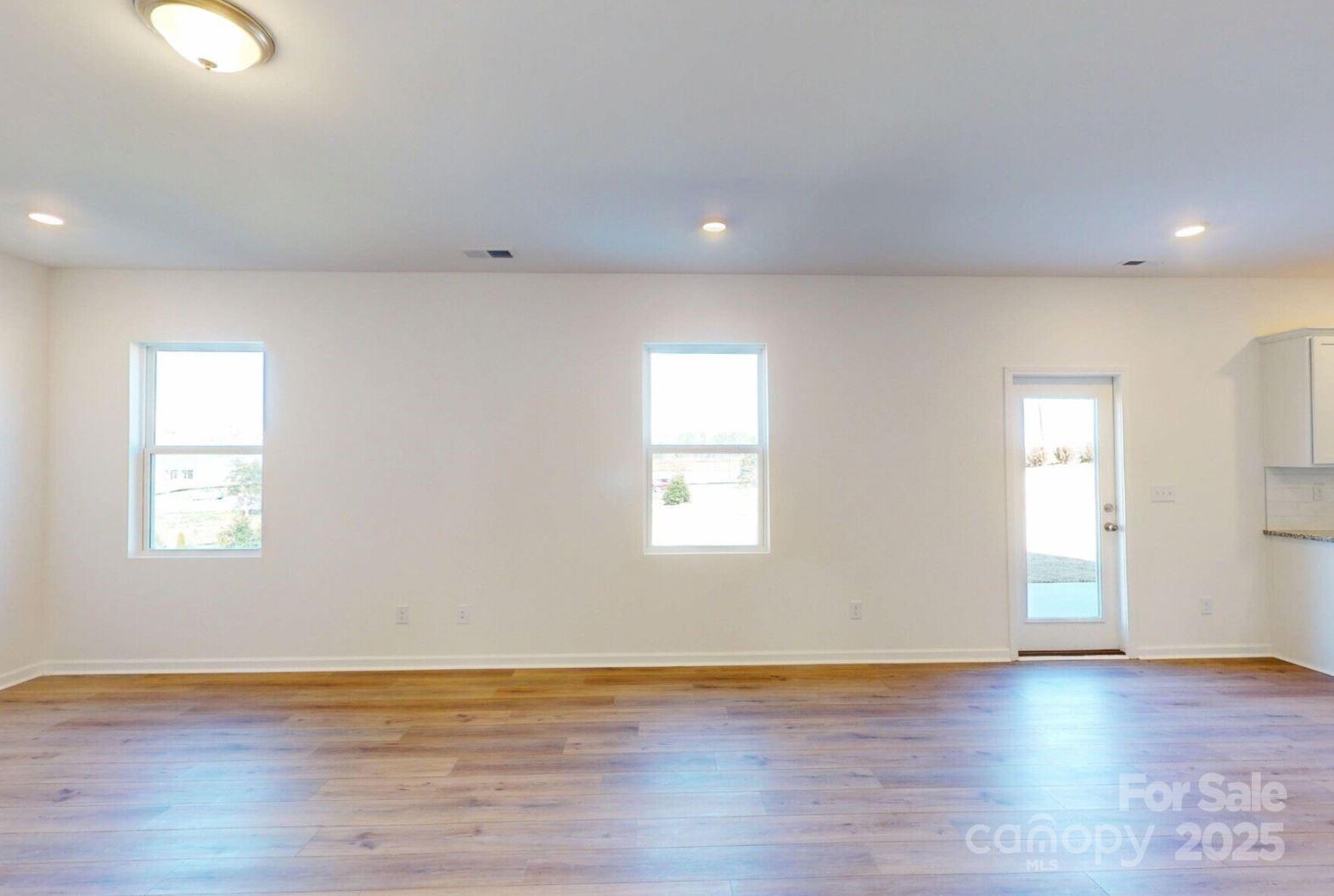 1829 Augustine Street Monroe, NC 28112 - Photo 7 of 21 a view of an empty room with wooden floor and a window