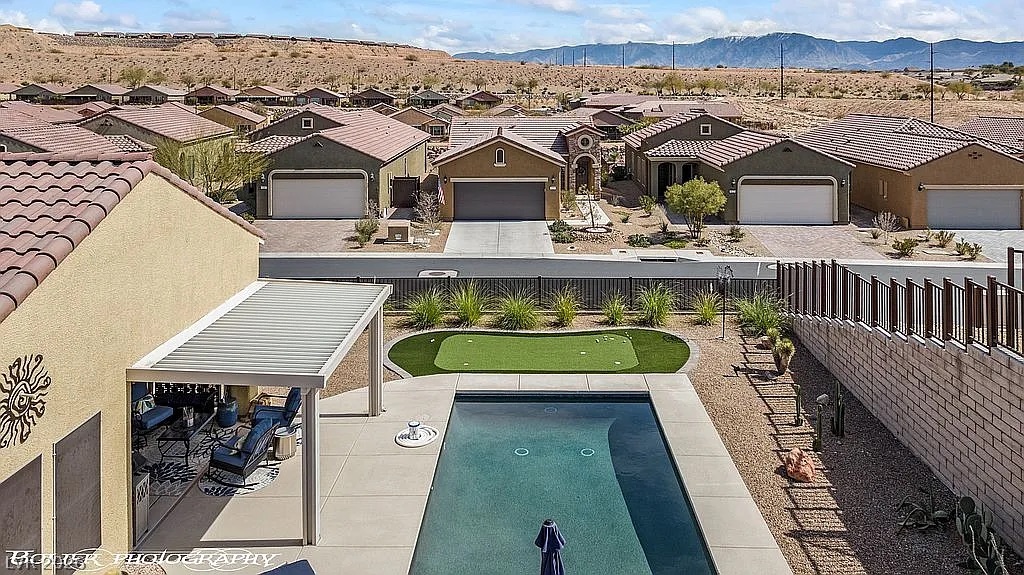 1304 Cottage Ridge Mesquite, NV 89034 - Photo 44 of 52 An aerial perspective reveals a private pool, putting green, and a welcoming covered patio.