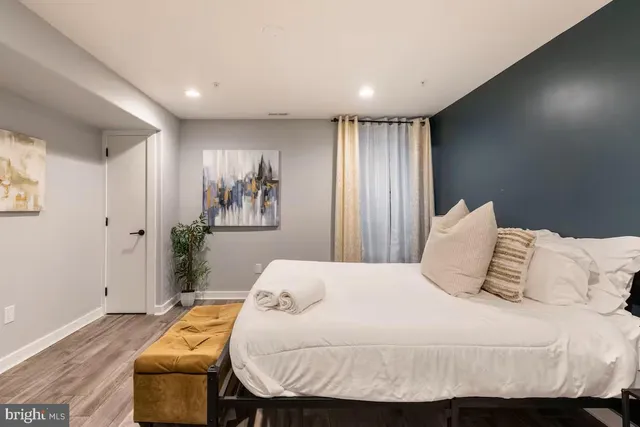 a bedroom with a bed and a window