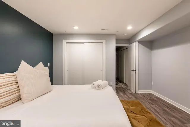 a bedroom with a bed and a large mirror