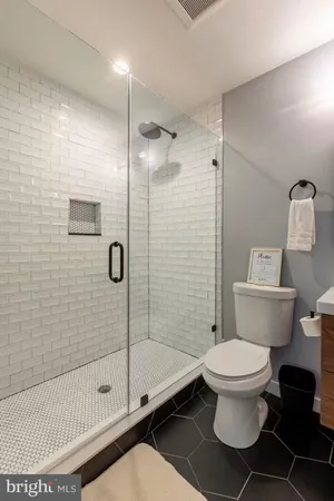 a bathroom with a toilet and a shower