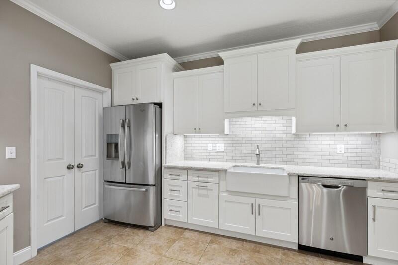 4542 Annabelle Lane Crestview, FL 32539 - Photo 12 of 36 a kitchen with white cabinets and white stainless steel appliances