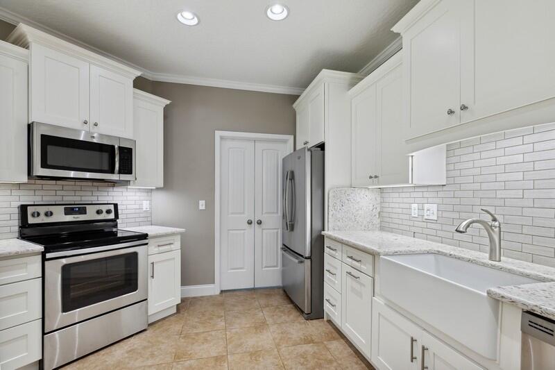 4542 Annabelle Lane Crestview, FL 32539 - Photo 16 of 36 a kitchen with appliances a sink and cabinets
