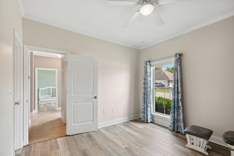 4542 Annabelle Lane Crestview, FL 32539 - Photo 21 of 36 an empty room with wooden floor mirror and windows