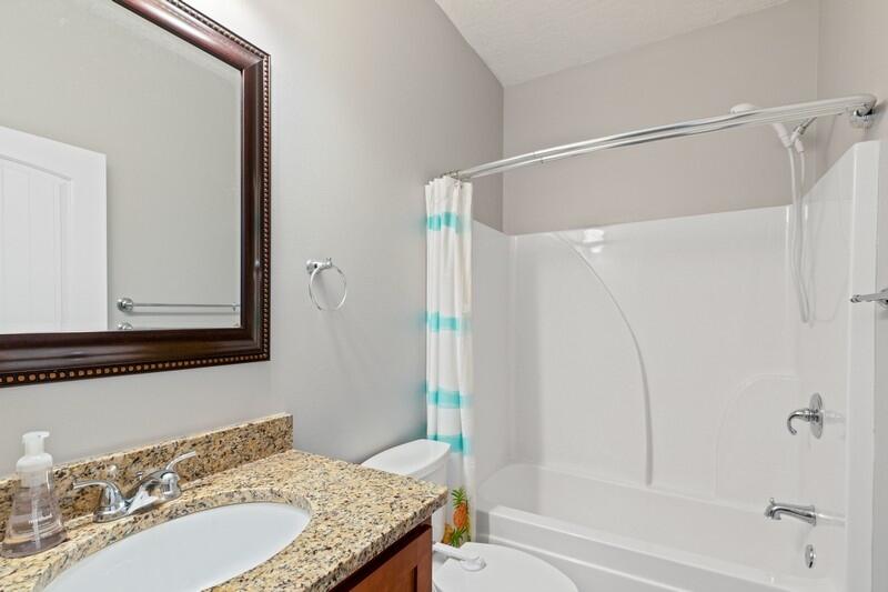 4542 Annabelle Lane Crestview, FL 32539 - Photo 22 of 36 a bathroom with a granite countertop sink mirror and a bathtub