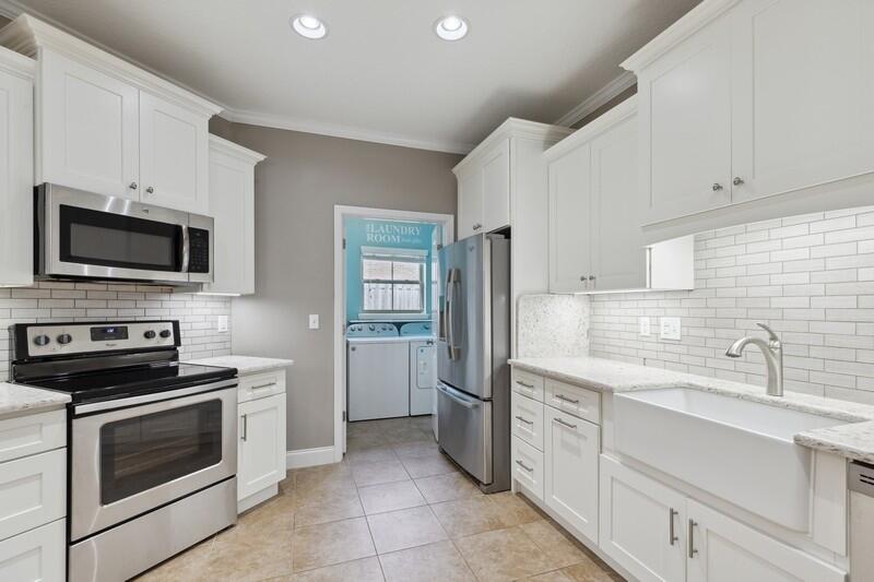 4542 Annabelle Lane Crestview, FL 32539 - Photo 26 of 36 a kitchen with a sink stove and microwave