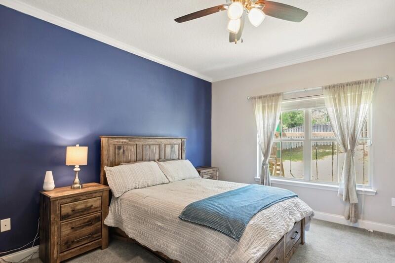 4542 Annabelle Lane Crestview, FL 32539 - Photo 27 of 36 a bedroom with a bed and a chandelier