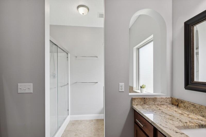 4542 Annabelle Lane Crestview, FL 32539 - Photo 30 of 36 a bathroom with a granite countertop sink and a window