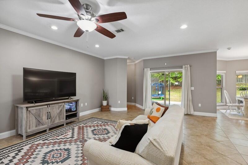4542 Annabelle Lane Crestview, FL 32539 - Photo 5 of 36 a living room with furniture and a flat screen tv