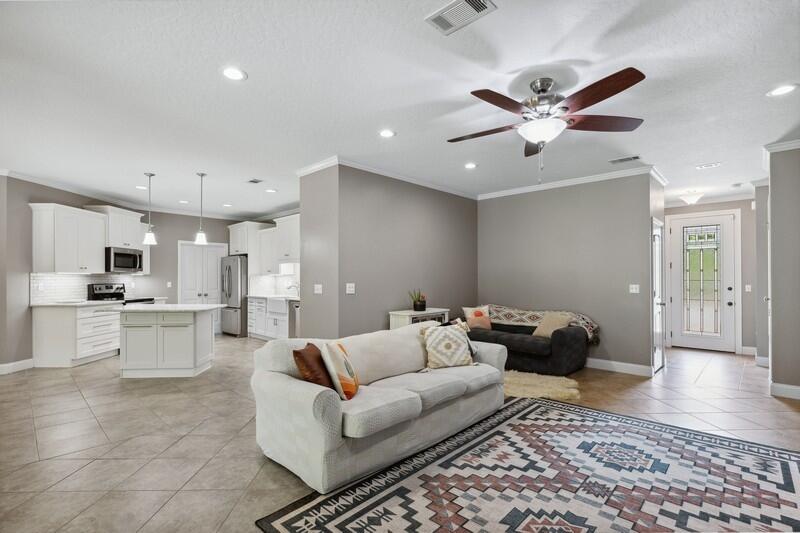 4542 Annabelle Lane Crestview, FL 32539 - Photo 7 of 36 a living room with furniture and a view of kitchen