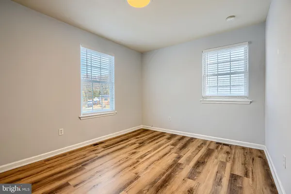 a view of a room with wooden floor and window