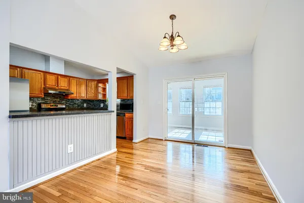 a view of a room with wooden floor and windows