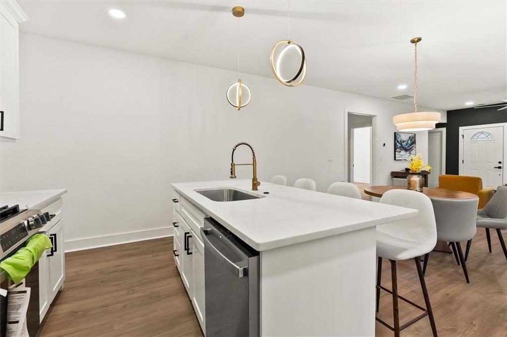 5580 Burrus Road Austell, GA 30106 - Photo 24 of 53 a kitchen with a table chairs sink and wooden floor