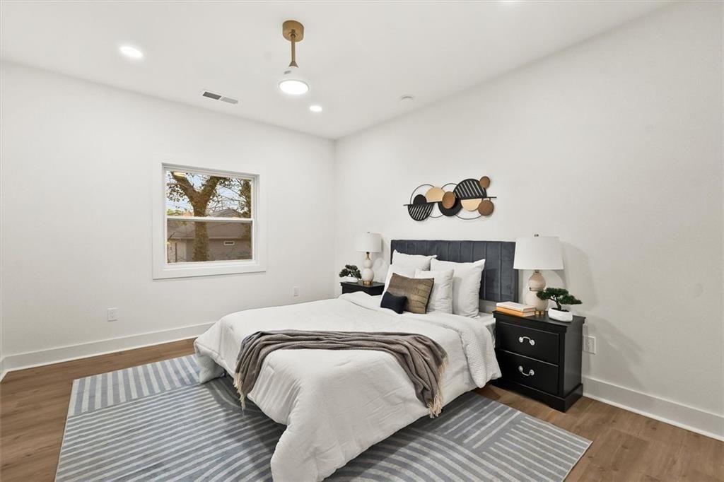 5580 Burrus Road Austell, GA 30106 - Photo 29 of 53 a bedroom with a bed and a painting on the wall