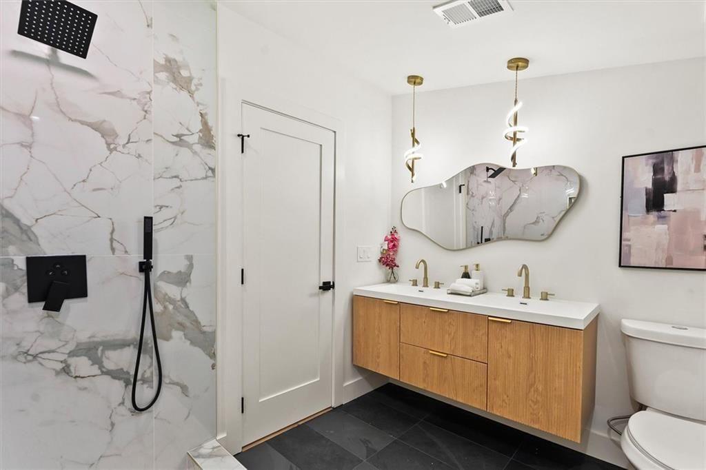 5580 Burrus Road Austell, GA 30106 - Photo 33 of 53 a bathroom with a toilet sink and mirror