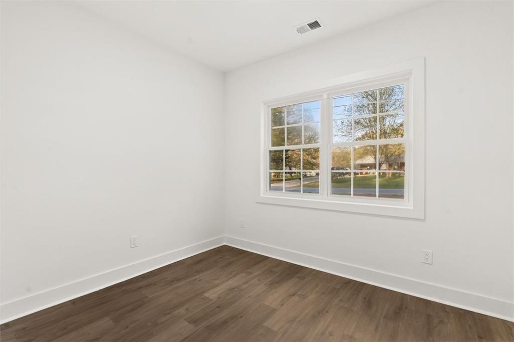 5580 Burrus Road Austell, GA 30106 - Photo 37 of 53 an empty room with wooden floor and windows