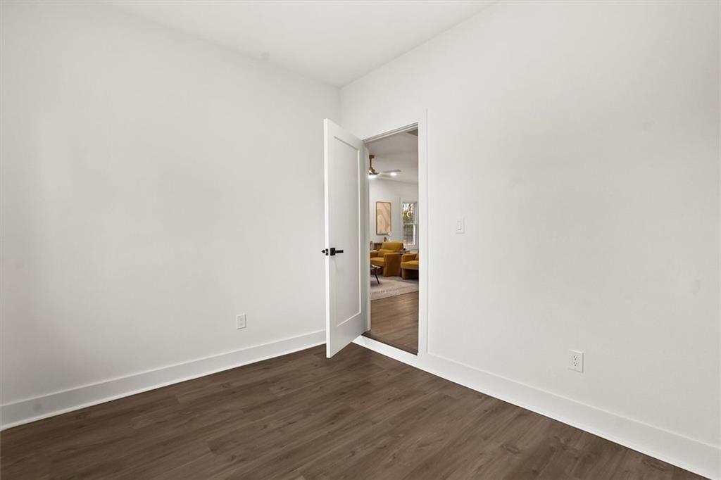 5580 Burrus Road Austell, GA 30106 - Photo 38 of 53 an empty room with wooden floor & windows