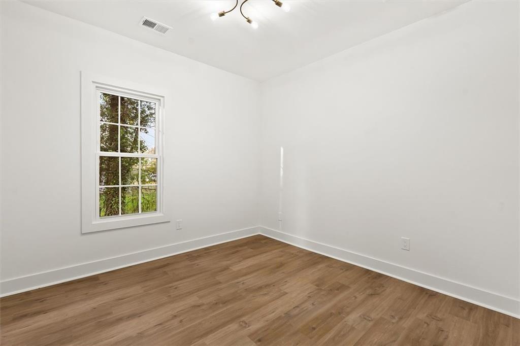 5580 Burrus Road Austell, GA 30106 - Photo 39 of 53 wooden floor in an empty room with a window