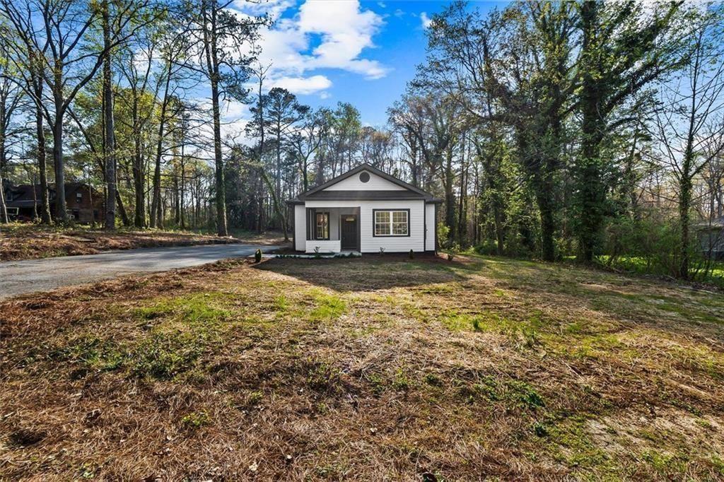 5580 Burrus Road Austell, GA 30106 - Photo 4 of 53 a front view of a house with a yard