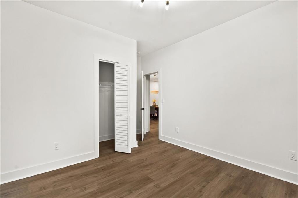 5580 Burrus Road Austell, GA 30106 - Photo 41 of 53 an empty room with wooden floor & windows