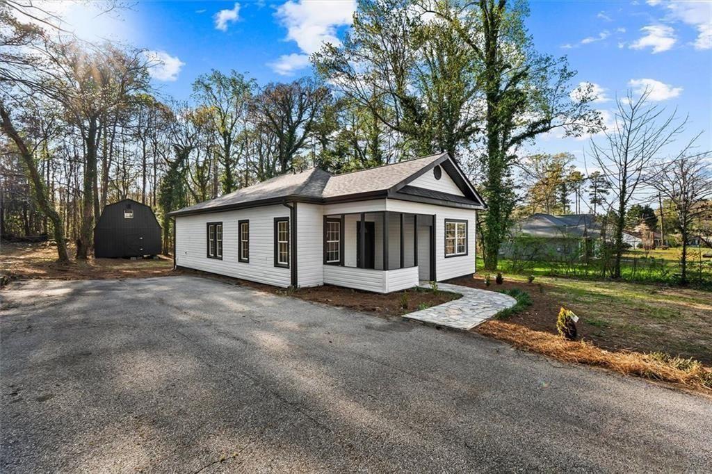 5580 Burrus Road Austell, GA 30106 - Photo 8 of 53 a view of a house with a yard and tree s