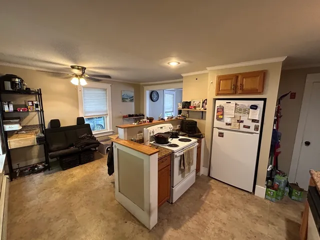 a bathroom with a sink a toilet a mirror and shower curtain