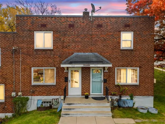 a front view of a house with yard