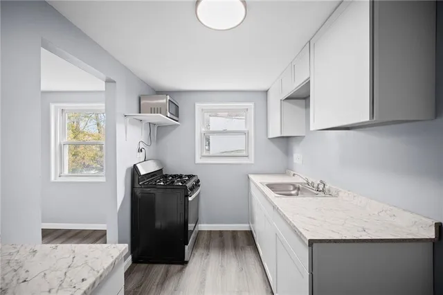 a kitchen with a refrigerator stove and sink