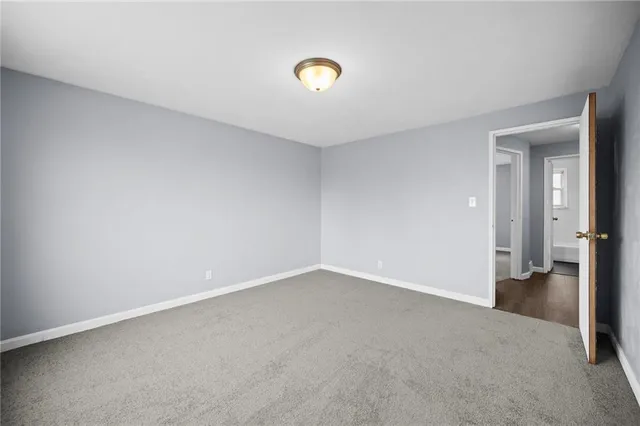 a view of an empty room and wooden floor
