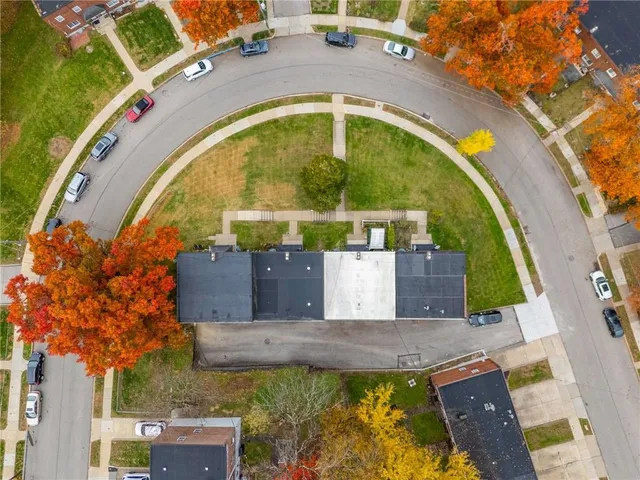 an aerial view of a house with a swimming pool