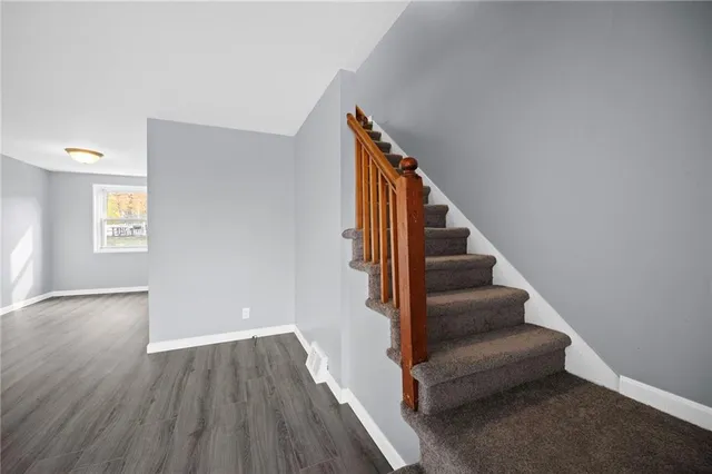 a view of entryway and hall with wooden floor