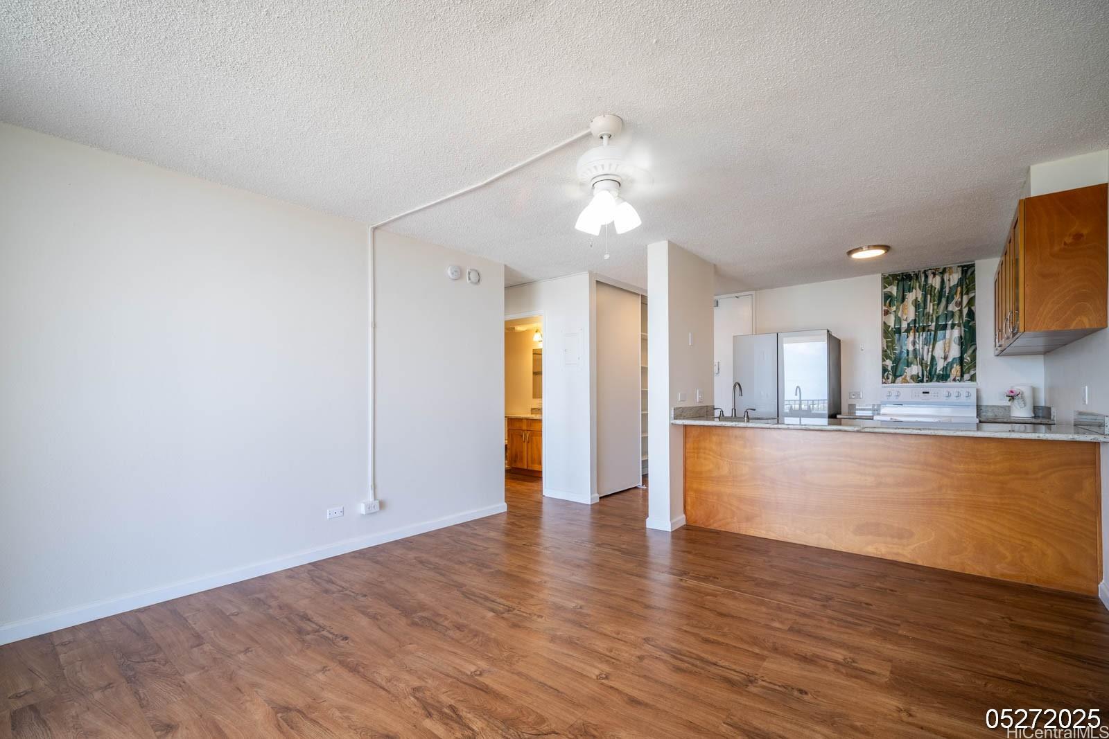 98-99 Uao Place, Unit 1705 Aiea, HI 96701 - Photo 12 of 25 a view of kitchen and hall with wooden floor